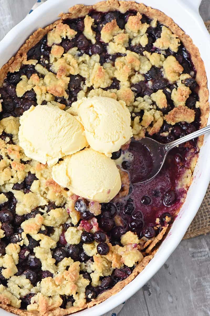 spoonful of blueberry cobbler with vanilla ice cream