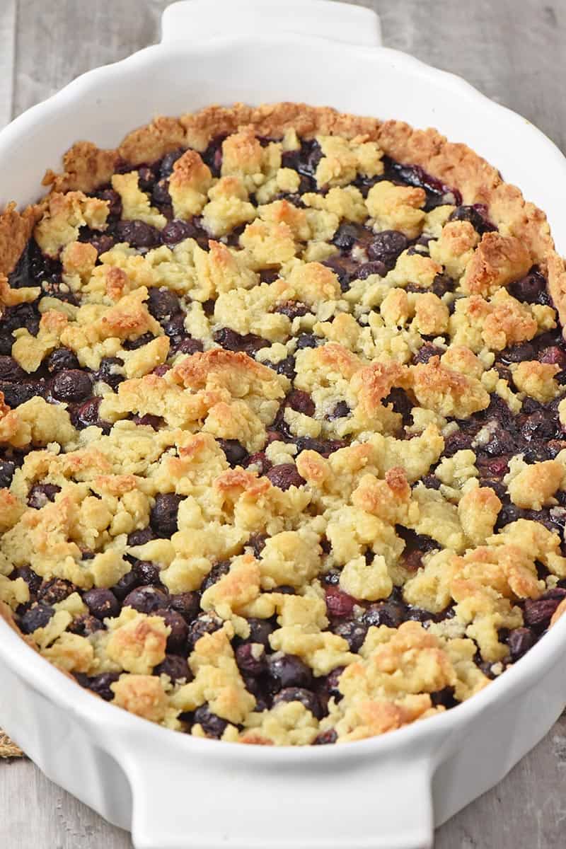 homemade blueberry cobbler in white baking dish