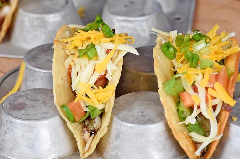 layer of cheese and green onions in fish tacos