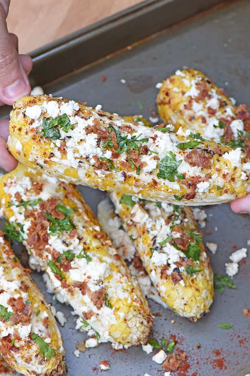holding an ear of Mexican corn
