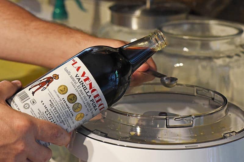 adding Mexican vanilla to mixer for homemade old fashioned ice cream recipe