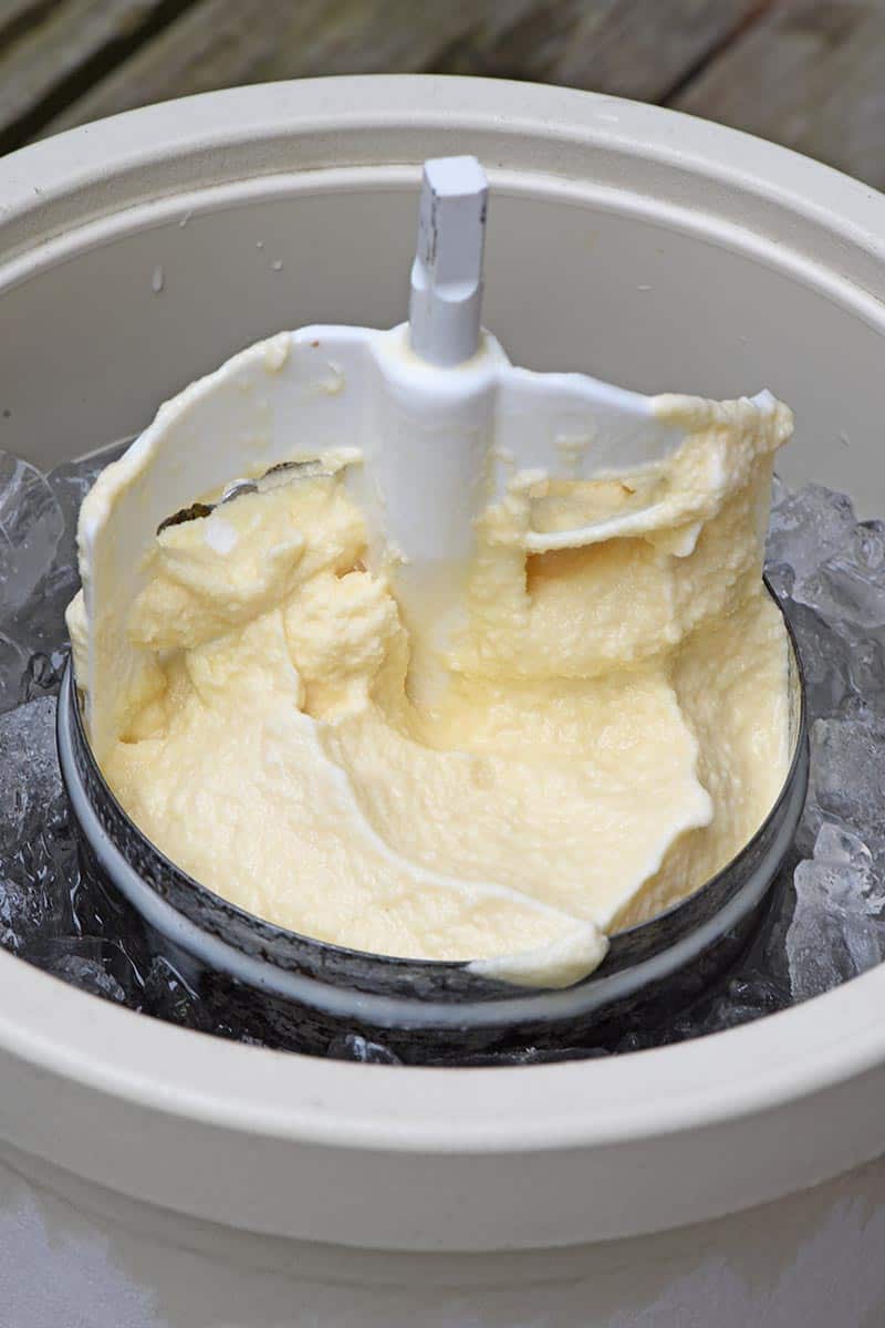 churning paddle in canister of vanilla old fashioned homemade ice cream