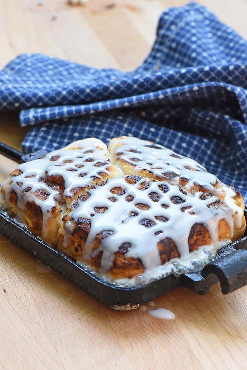 frosted pie iron cinnamon rolls in a pie iron, hot off the grill