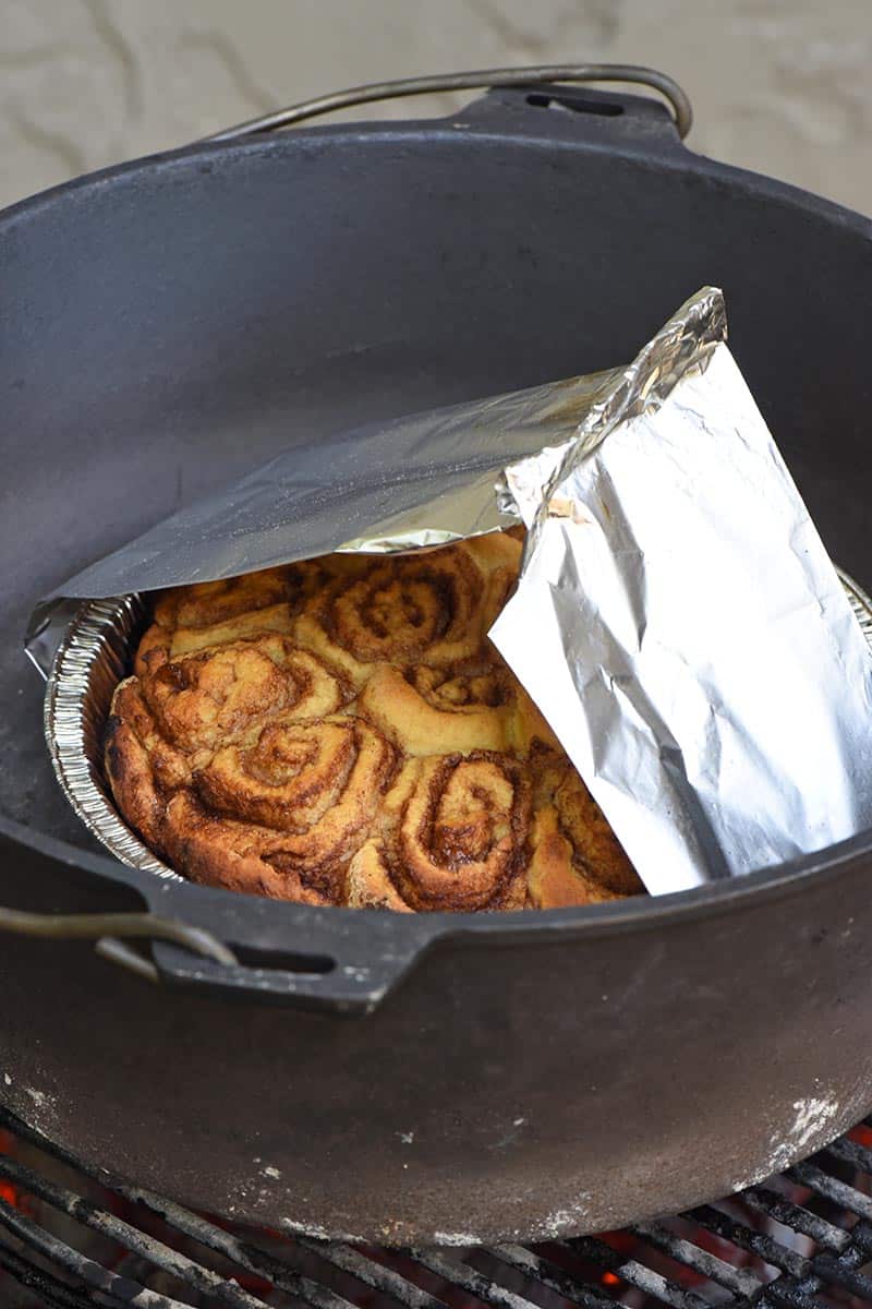 biscuit mix Dutch oven campfire cinnamon rolls in foil pan, cooking in cast iron Dutch oven on the grill