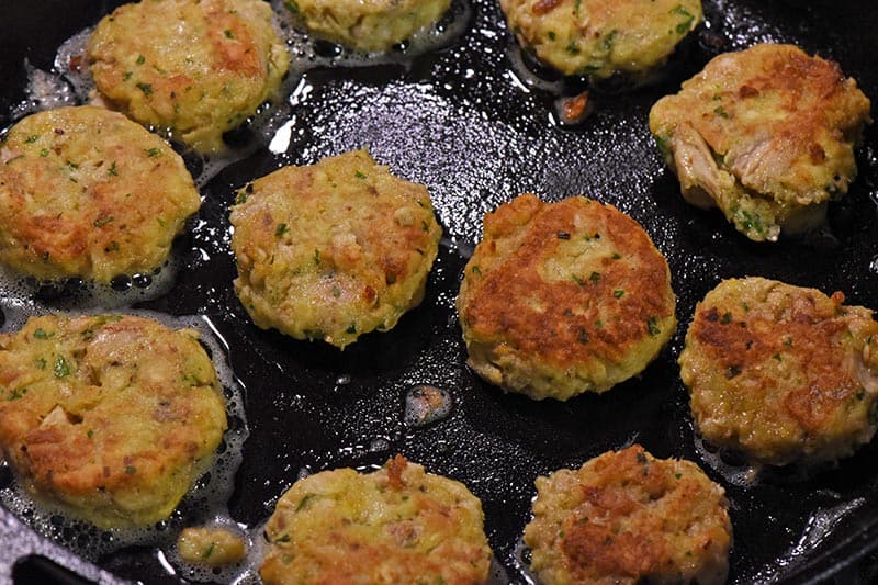 fried salmon patties in cast iron skillet