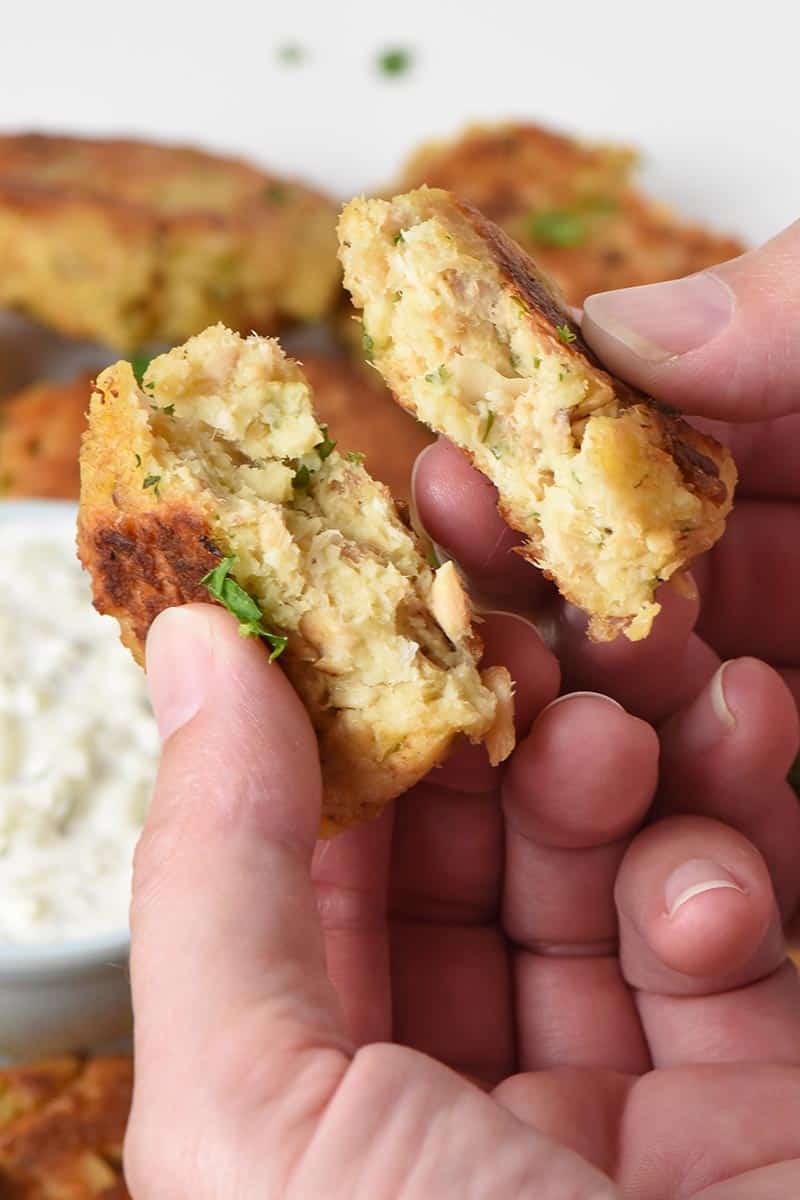 salmon patties torn in half in hands