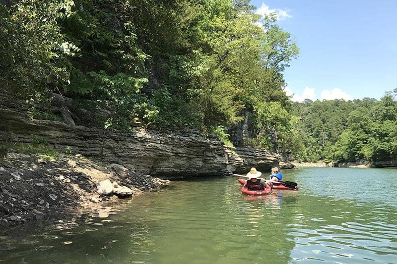 boys paddling in a cove on Beaver Lake