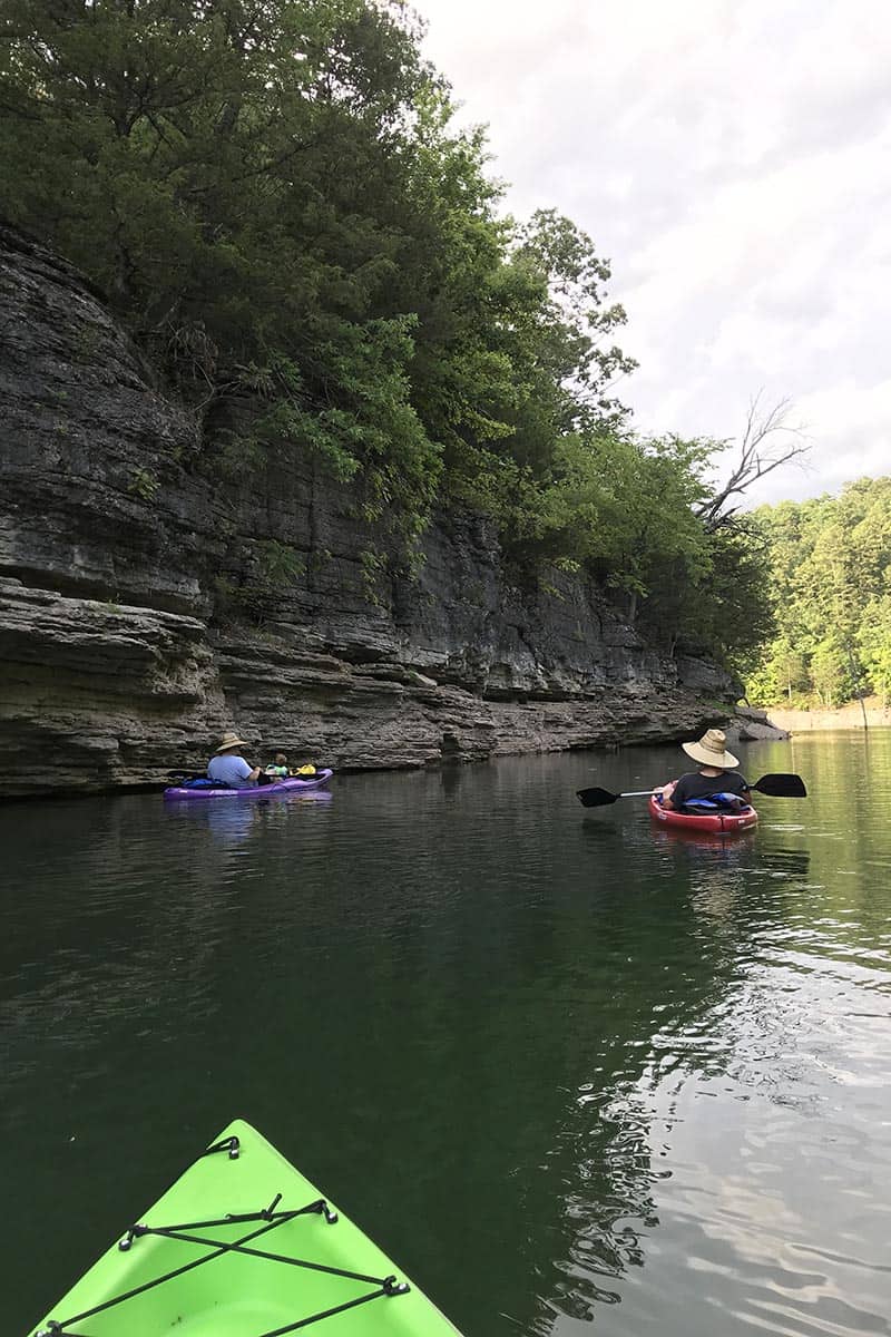 kayaking beside bluffs near Pigeon Roost Trail on Beaver Lake