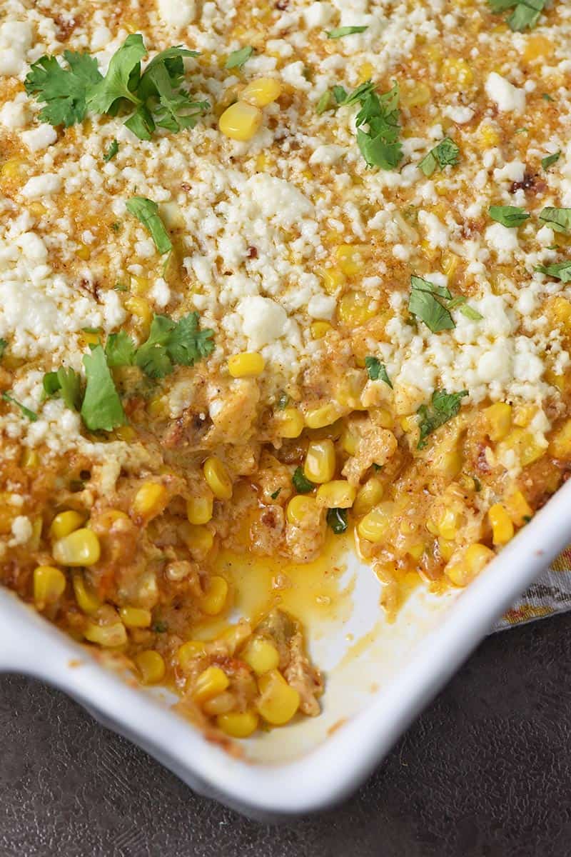 easy Mexican corn casserole in a white baking dish with cilantro