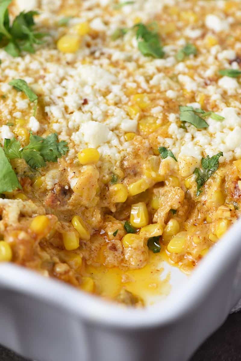 Mexican corn casserole, made like Mexican street corn, in white casserole dish
