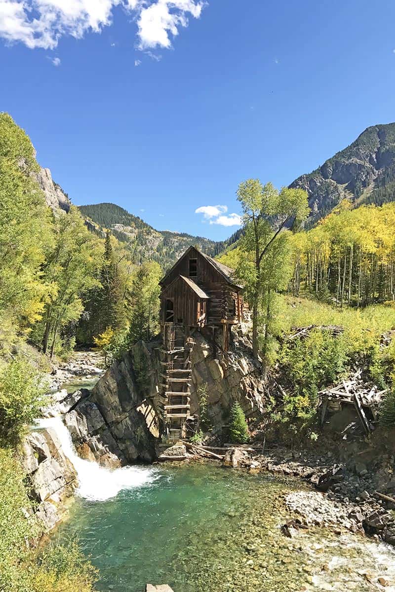 Crystal River flowing around and below Crystal Mill, Colorado, and golden aspens