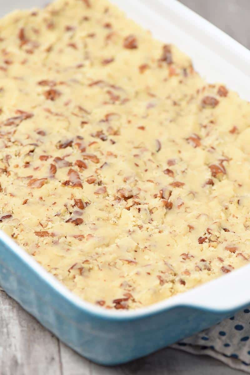 simple homemade pie crust with pecans in a blue 13x9 inch baking dish