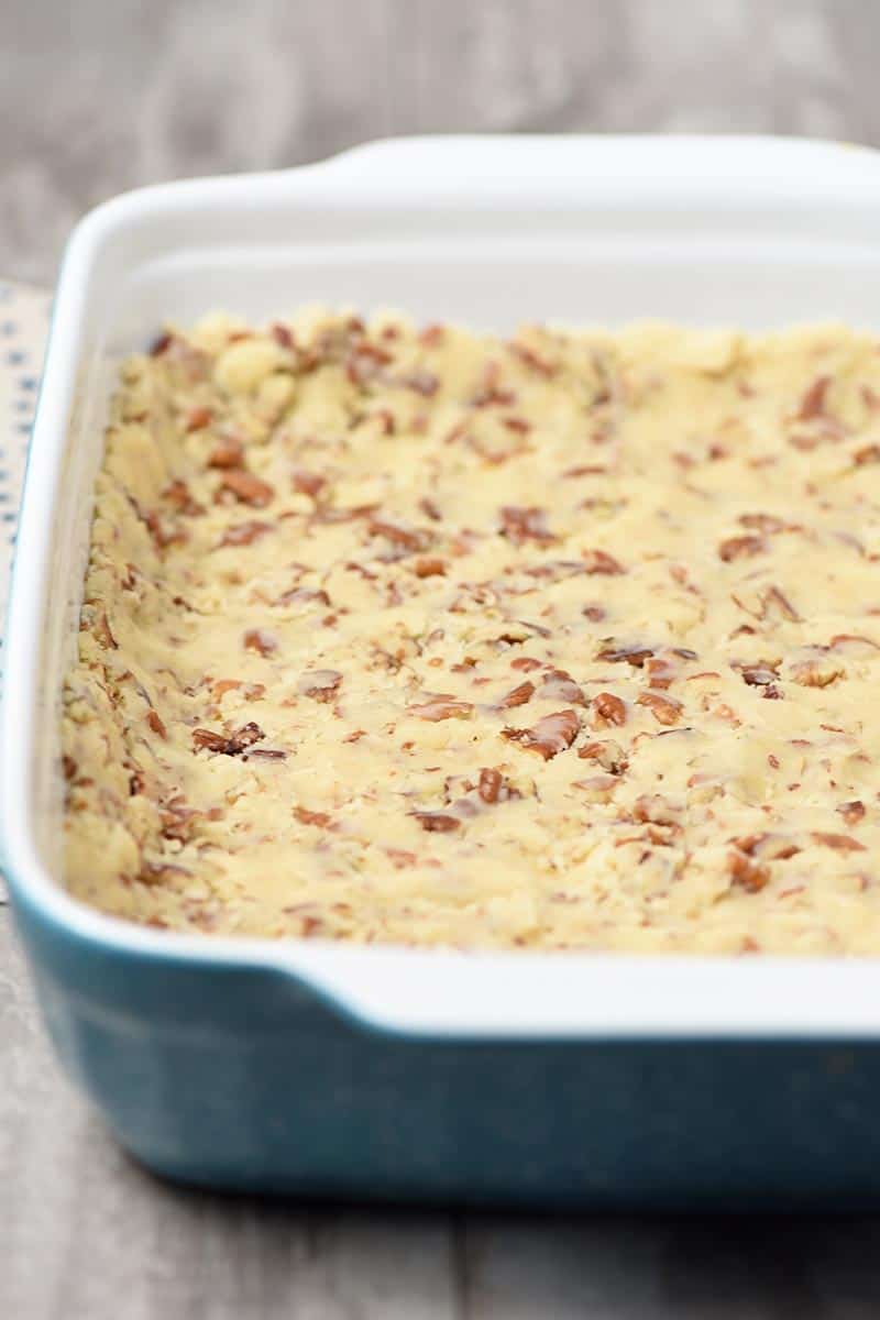 pie crust with pecans in blue 13x9 inch baking dish