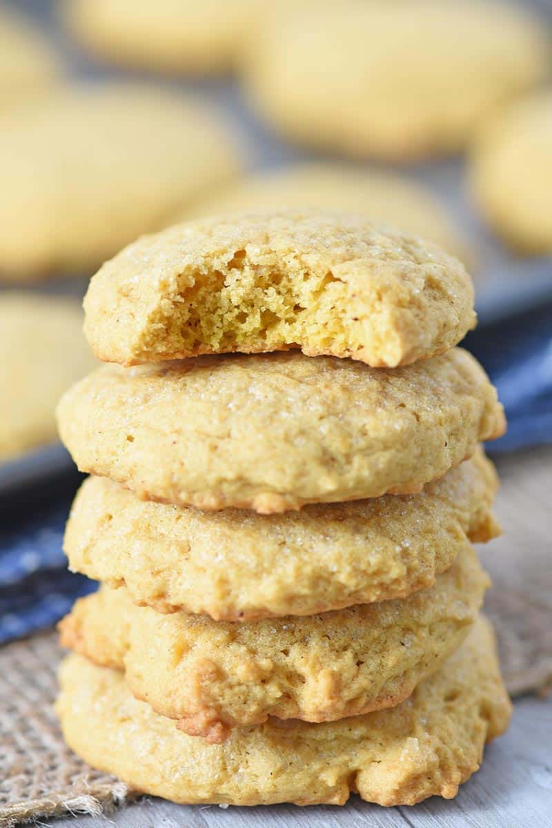 stack of soft pumpkin spice sugar cookies, made from scratch, on wood countertop with burlap cloth