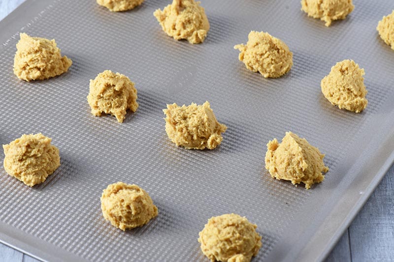 scoops of pumpkin sugar cookie dough on ungreased OXO cookie sheet