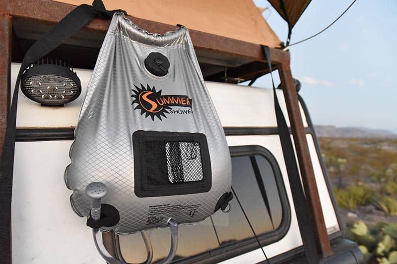 portable shower for camping, hanging on a camp trailer, in the backcountry of Big Bend National Park