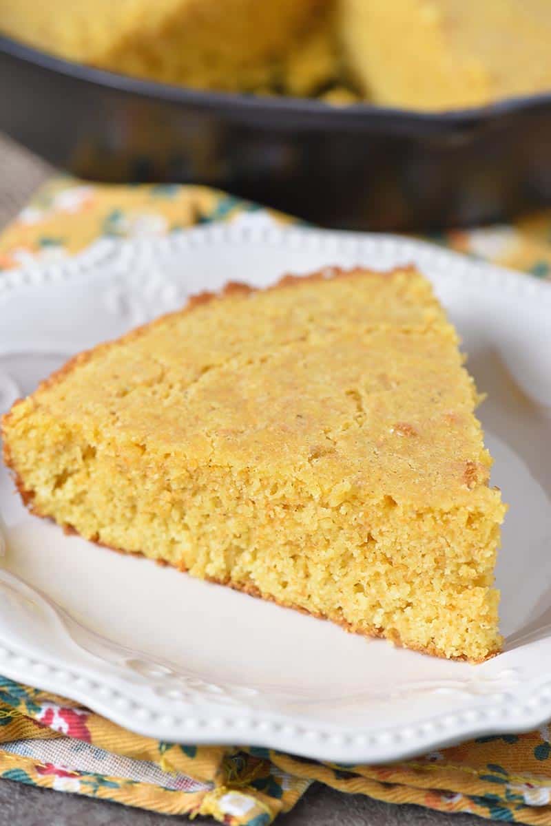 slice of buttermilk cornbread on white pioneer woman plate