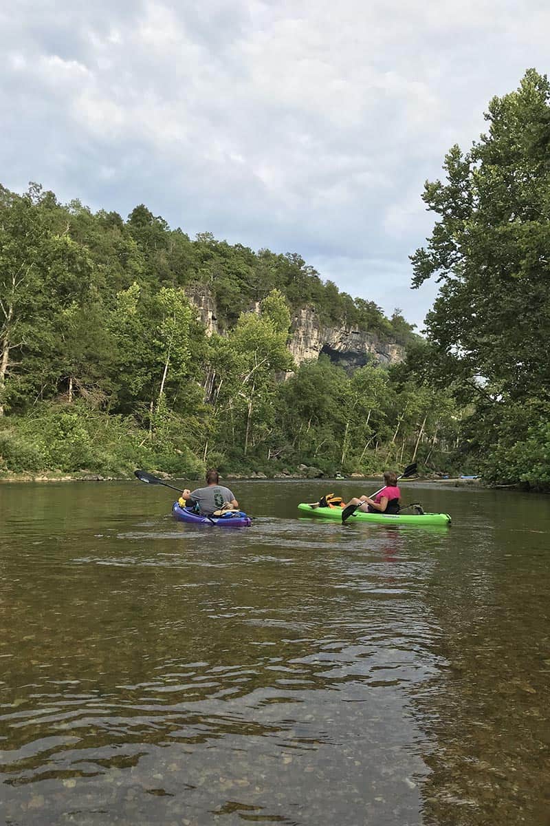 Jacks Fork kayaking below bluff cavern overlooking Jacks Fork River, part of the Ozark National Scenic Riverways