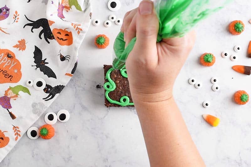 swirling pumpkin vines with green icing onto pumpkin patch halloween brownies halloween treats