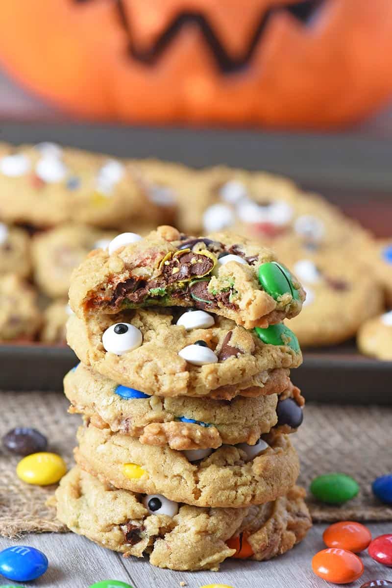 stack of M&M's monster cookies with bite taken out of top cookie