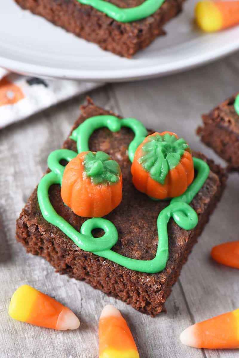 finished pumpkin patch halloween brownies with candy corn pumpkins and green icing pumpkin vines