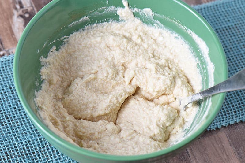 whipped cream mixture for butterbeer recipe in green mixing bowl