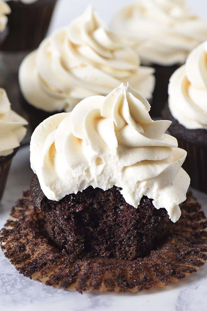 bite out of chocolate cupcake topped with fluffy butterbeer buttercream frosting