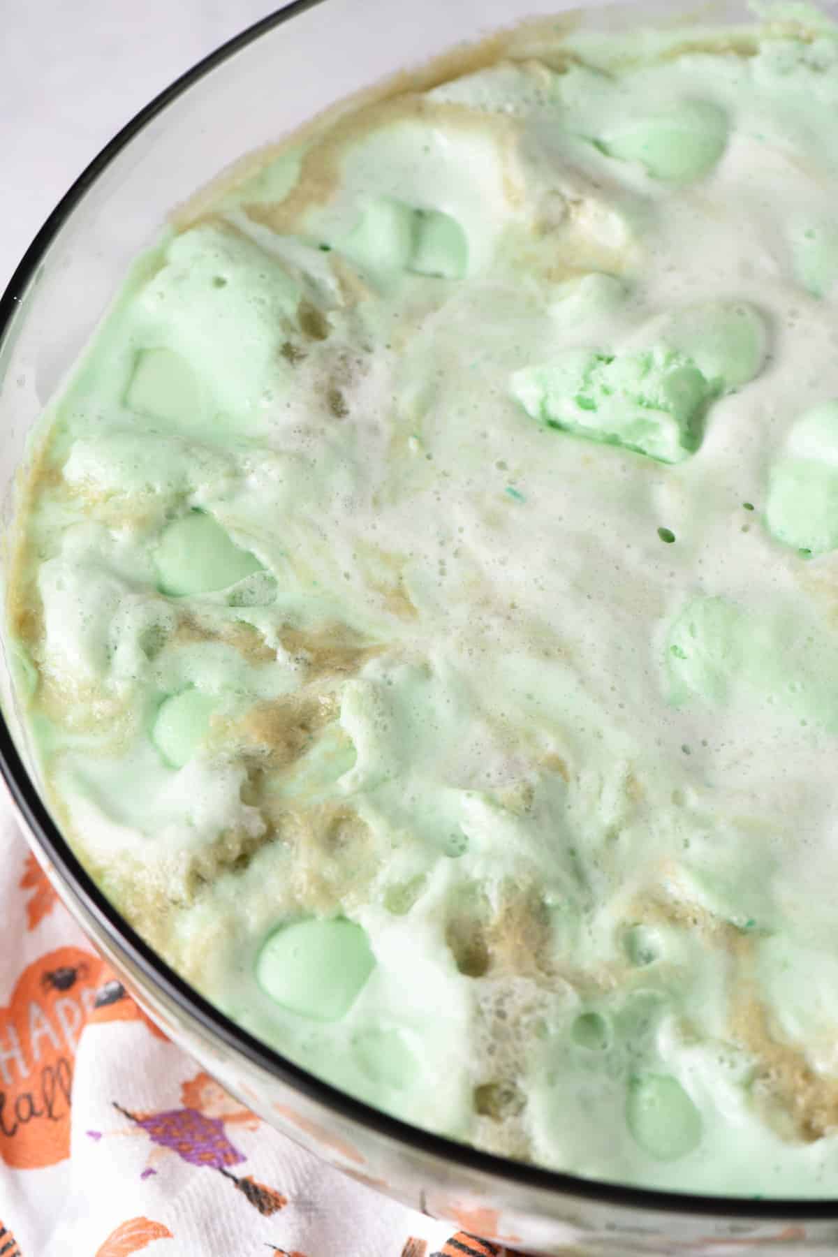 large punch bowl filled with green lime sherbet punch