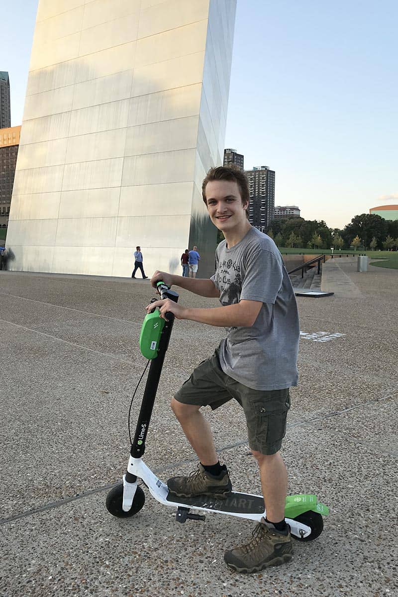 teen riding scooters in Gateway Arch National Park in St. Louis, Missouri