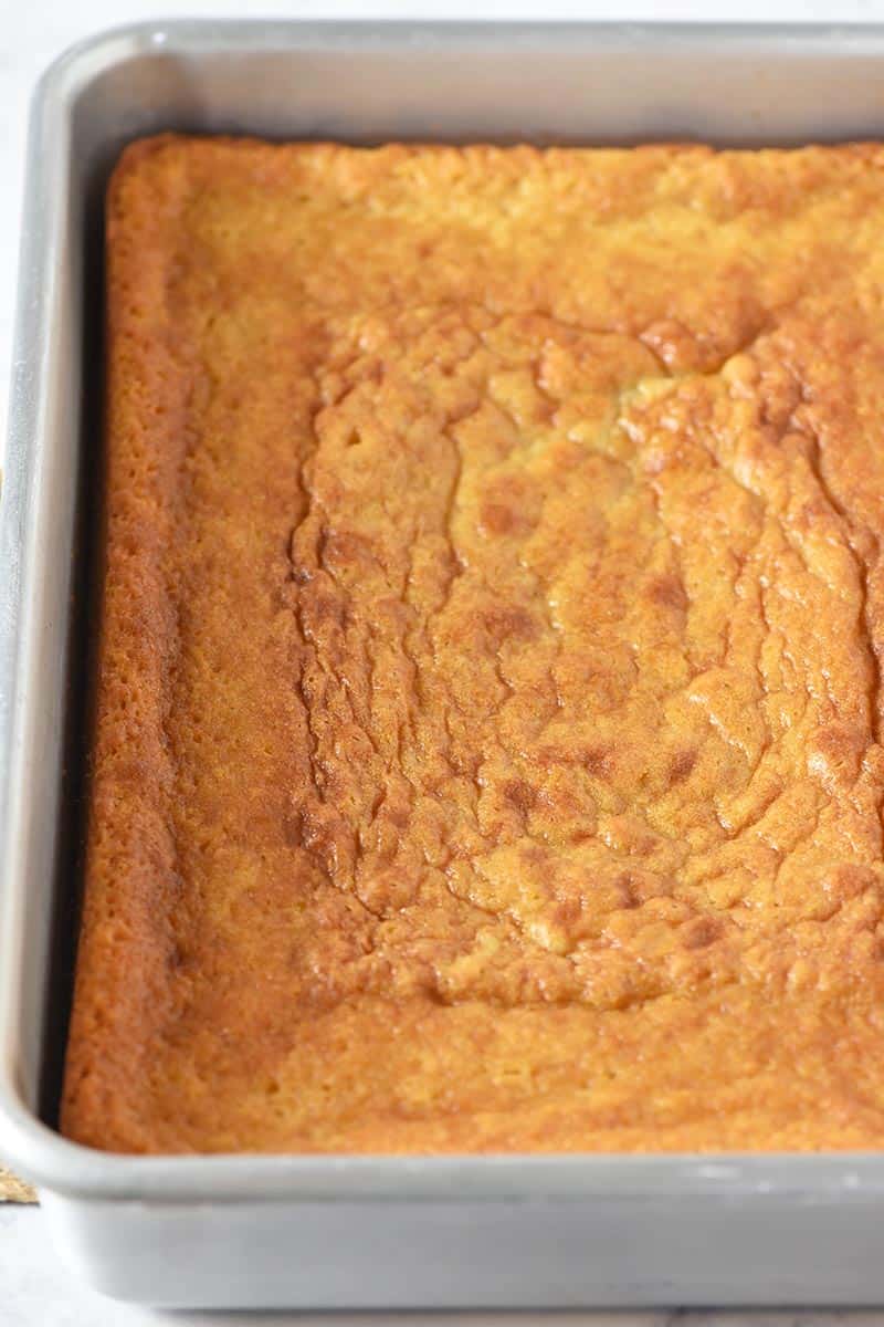 baked yellow cake cooling in metal cake pan