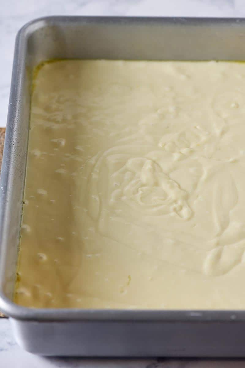 easy yellow cake recipe cake batter in cake pan, unbaked, ready for the oven