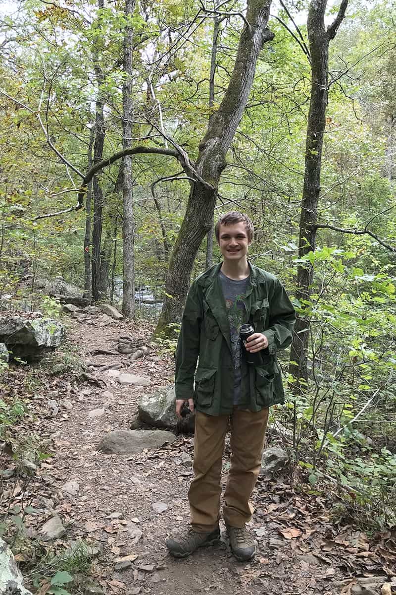 teen hiking Cedar Falls Trail in Petit Jean State Park