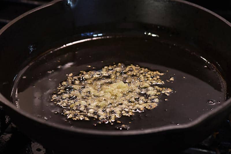 sauté garlic in bacon grease in iron skillet on stovetop for pepperoni pizza sloppy joes