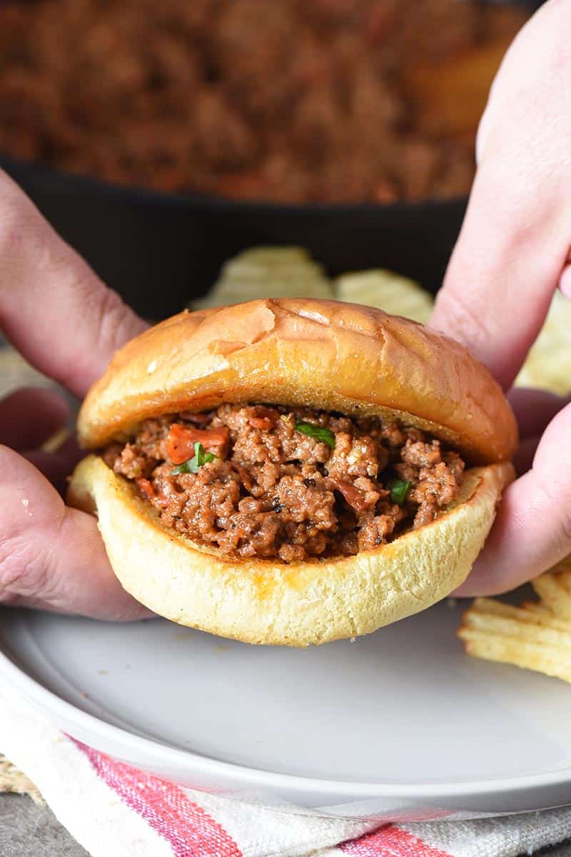 holding a pizza sloppy joe in hands