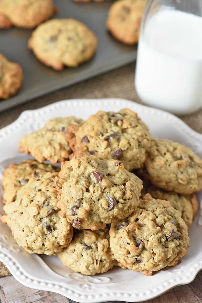 plate of buttermilk oatmeal chocolate chip cookies with tall glass of ice cold milk