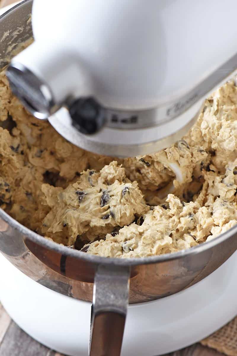 mixing up best oatmeal chocolate chip cookies dough with rolled oats in white KitchenAid mixer