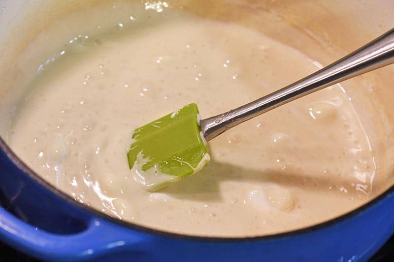 melted marshmallows for Rice crispy treats in blue Dutch oven