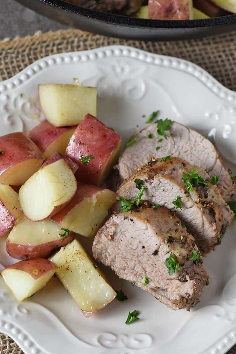 pork tenderloin and potatoes, sliced and placed on white plate