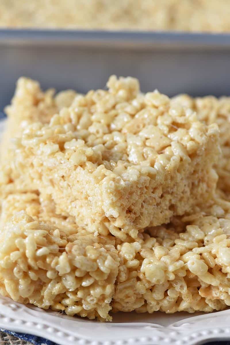 Rice Krispie squares stacked on a white plate