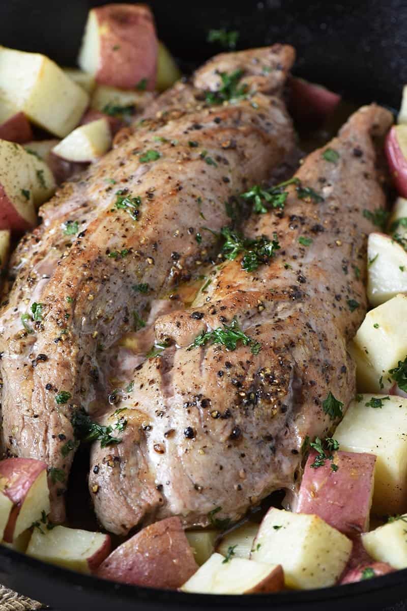 roasted pork tenderloin with potatoes in cast iron skillet
