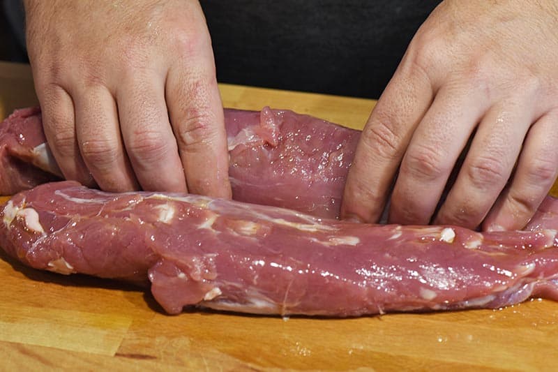 rubbing olive oil into pork tenderloin before cooking