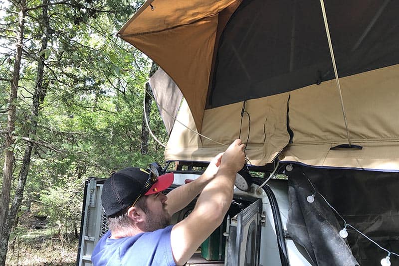 setting up a rooftop tent for tent camping