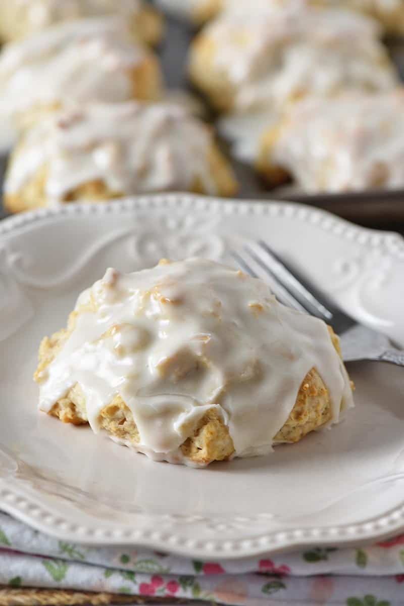 biscuit mix cinnamon biscuit with icing on white plate with fork