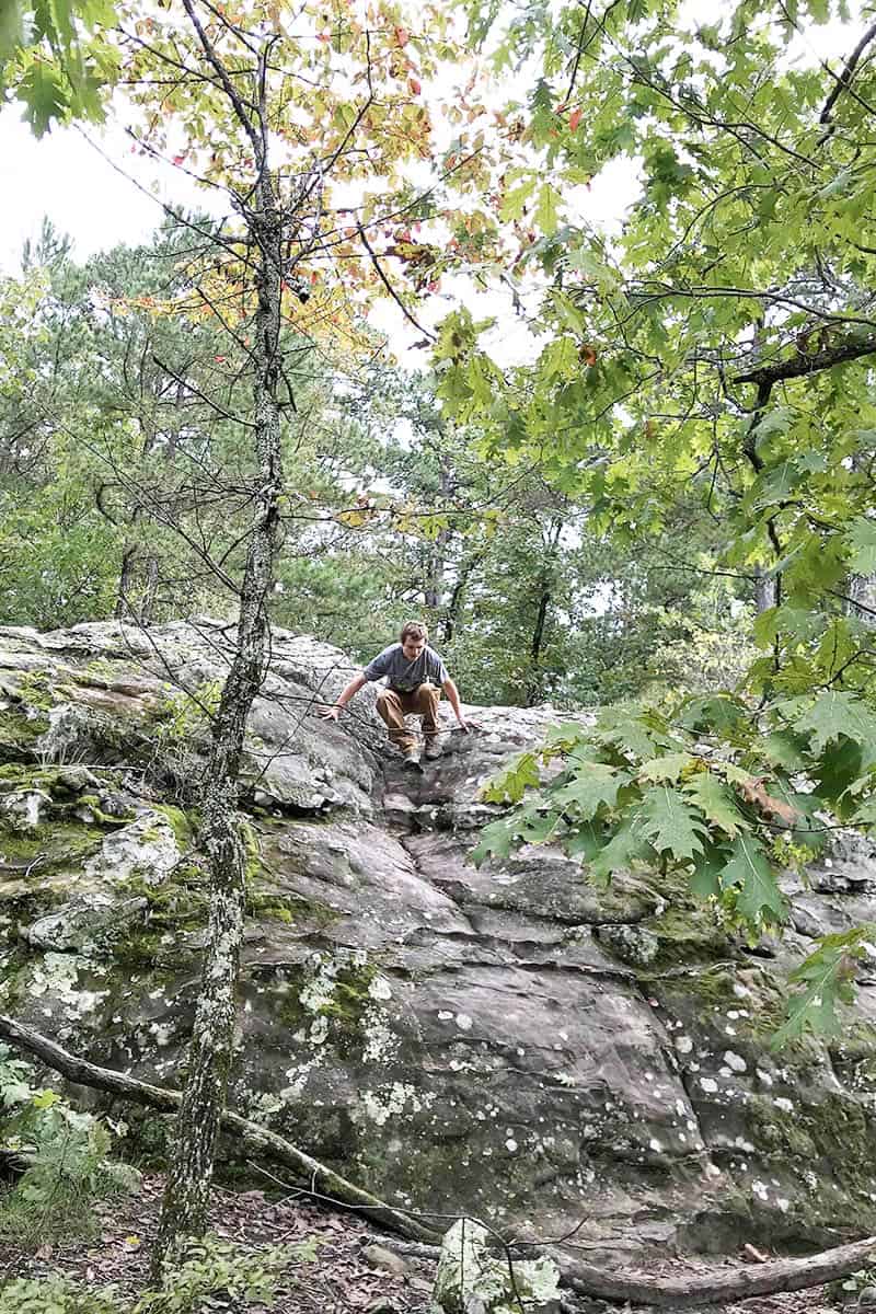 climbing around on gigantic boulder and rock formations on Bear Cave Trail in Petit Jean State Park, Arkansas