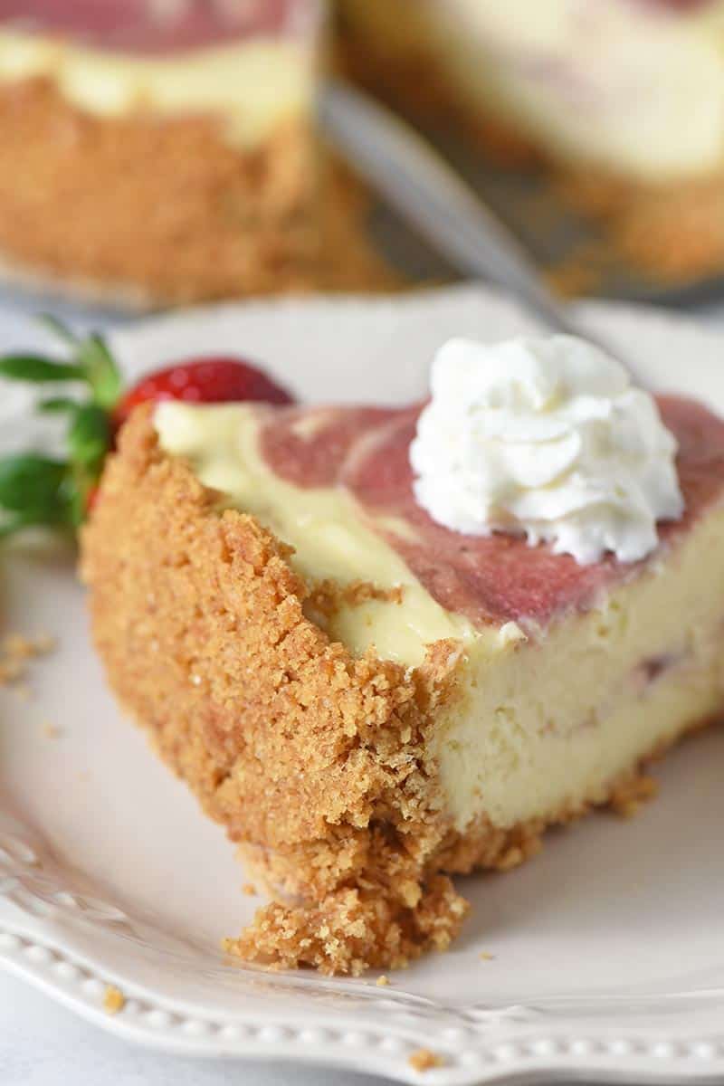 slice of cheesecake with easy graham cracker crust and whipped cream