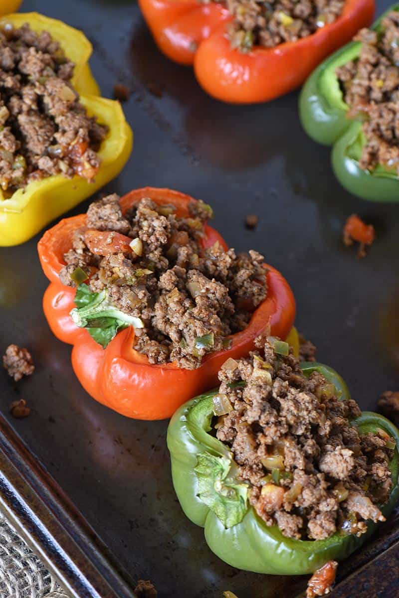 ground beef taco stuffed peppers on baking sheet