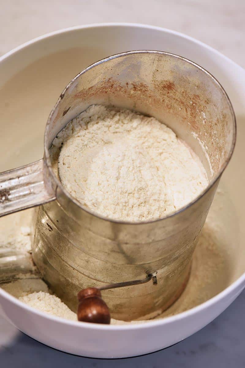 sifting dry ingredients for chocolate chip pancakes from scratch
