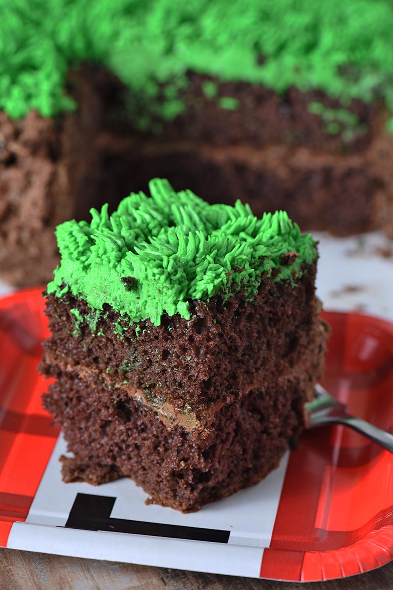 slice of Minecraft grass block cake on TNT paper party plate