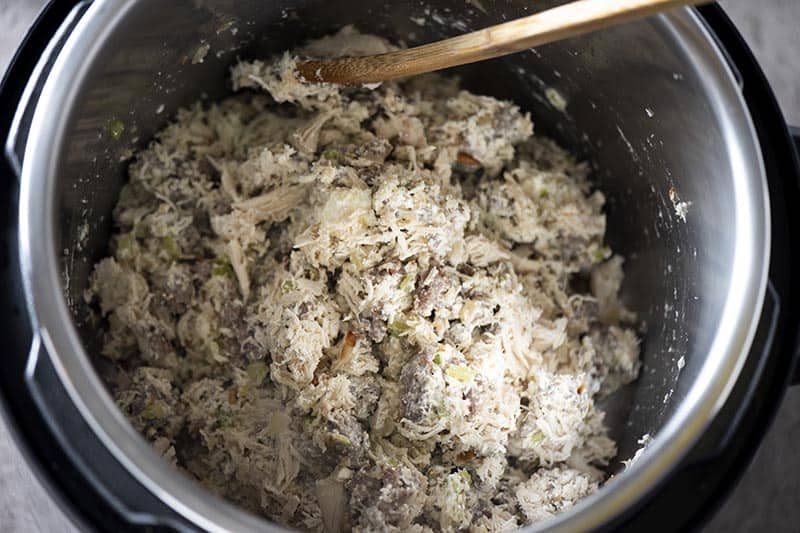 mixing cream cheese and chicken into low carb cheesy chicken casserole in Instant Pot pressure cooker