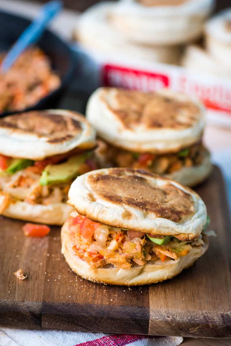 grilled taco tuna melt sandwich, made with English muffins, on wooden cutting board